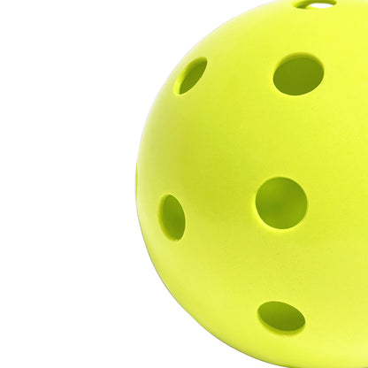 Perforated Surface of Chartreuse Pickleball Against a White Background 
