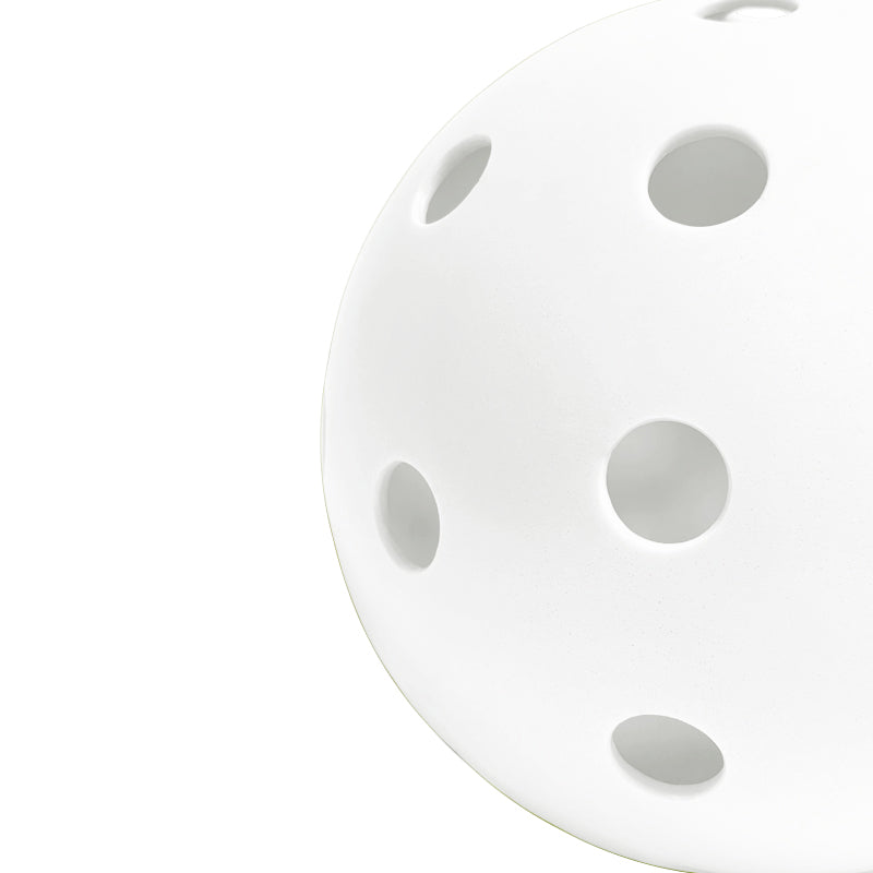 Perforated Surface of White Pickleball Against a White Background
